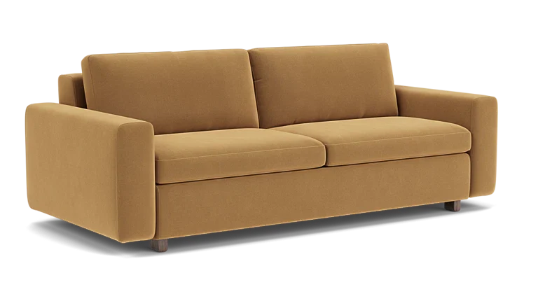 Introducing the Reva Storage Sofa: This contemporary mustard-colored sofa features two seat cushions and two back cushions, complemented by wide armrests and supported by four short, dark wooden legs. Its design is both minimalist and elegant.