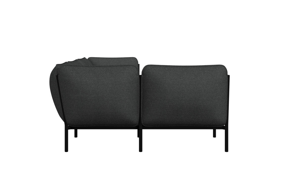 The back view of the Kumo Corner Sofa Left with Armrest showcases a modern, dark gray design. It features squared cushions and slim black metal legs, accentuating its sleek and contemporary look.