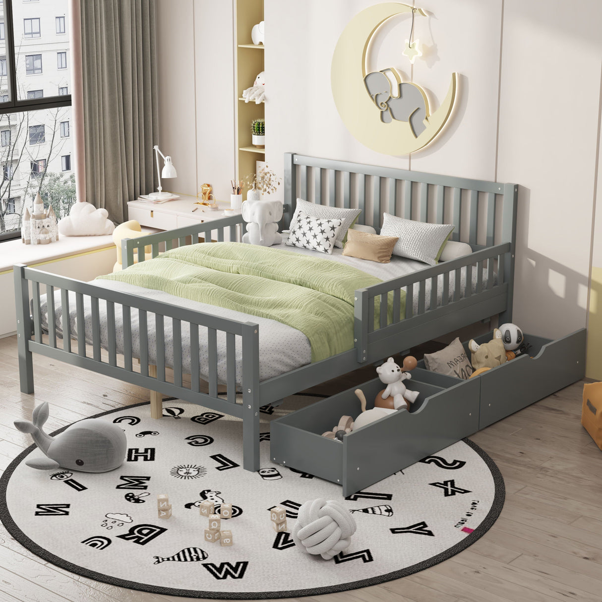 A child's bedroom features a Platform Bed with Guardrails on both sides, green bedding, and stuffed animals. There's a round rug with letters, a big window with curtains, and toys stored in two pull-out drawers under the bed. A bear artwork hangs above this cozy setup.