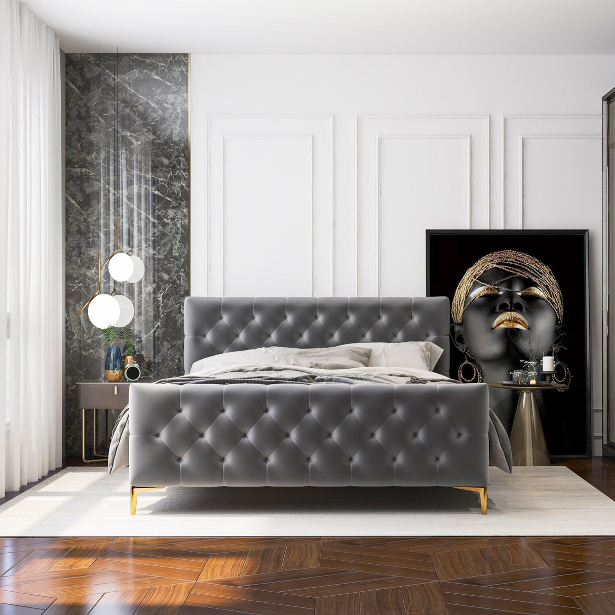 A modern bedroom showcases the Bailey - Elegant Design Bed, with gray tufting and gold legs. It includes a bedside table adorned with an orb lamp and decor, and a large framed African-inspired art piece. The herringbone floor pattern and marble accent wall enhance the white surroundings.
