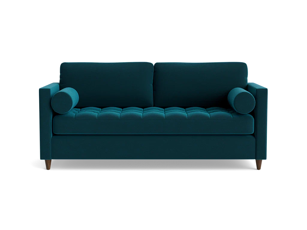 The Briar Sleeper Sofa is showcased against a plain black background, featuring button-tufted cushions and cylindrical armrests in a dark teal color. It boasts wooden legs and a modern design.