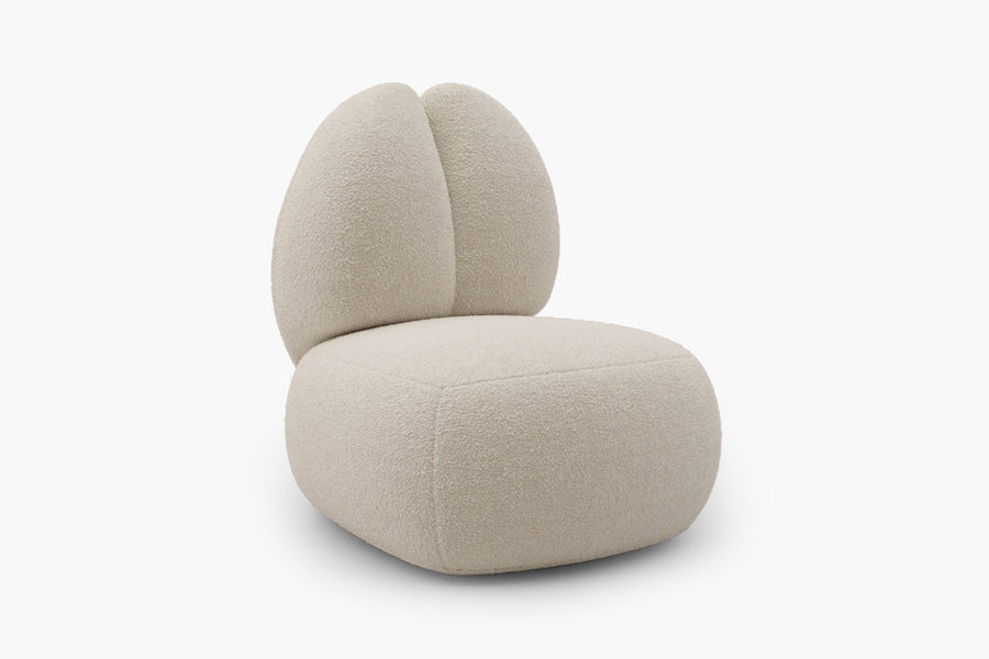 Introducing the Moony Fleece Curved Lounge Chair by Acanva, a modern piece featuring plush light beige fabric. This chair boasts a unique rounded seat resembling a cushion, complemented by a high, split backrest in the shape of two ovals. Its minimalist design is highlighted against a white background.