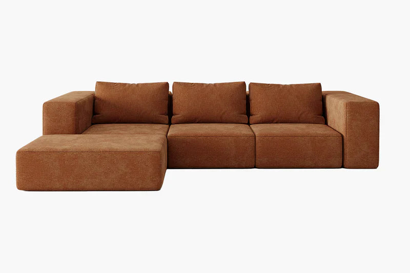 The Atlas Modular Sofa by Acanva is a large brown sectional with a modern, minimalist design, featuring three back cushions and an extended chaise lounge on the left side against a white background.