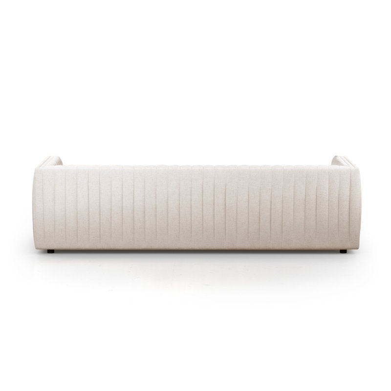 The Brandt 97'' Upholstered Sofa in beige, featuring a modern design with a quilted pattern on the backrest, is displayed from the back against a white background. The sofa boasts a sleek, rectangular shape complemented by slightly rounded armrests.