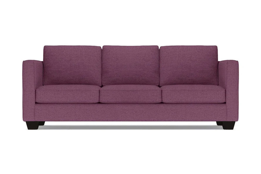 The Catalina Sofa is a three-seater in purple, featuring square arms and a modern design with three cushions and a low profile. It is displayed against a plain white background.