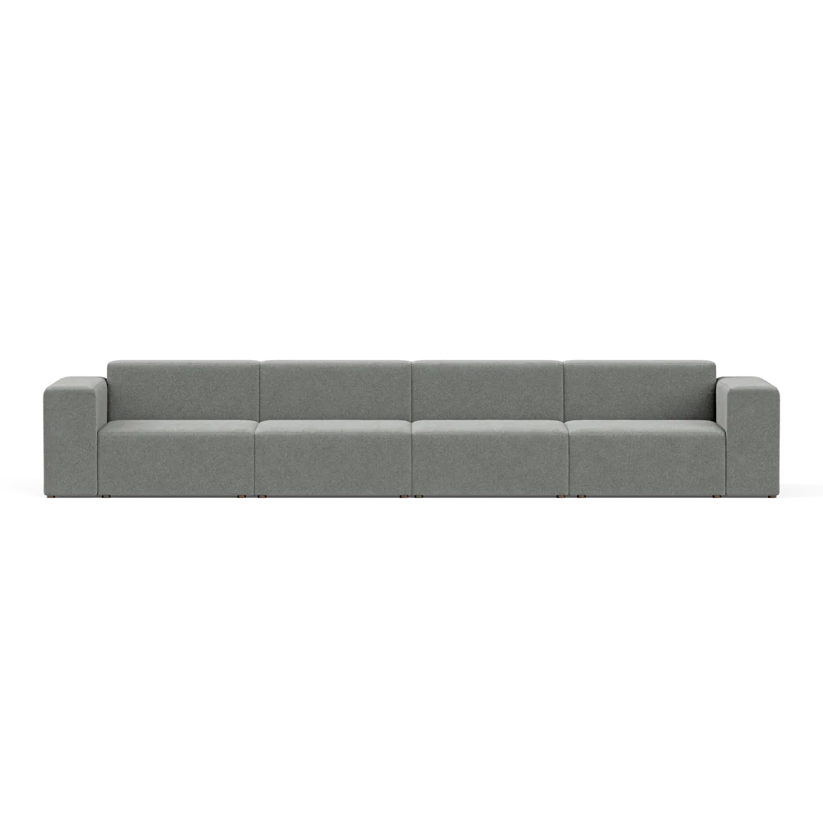 A large, modern Four-Seater Form Sectional in gray is showcased against a plain backdrop. Its minimalist design includes four wide seats and square armrests, offering a sleek and contemporary appearance.