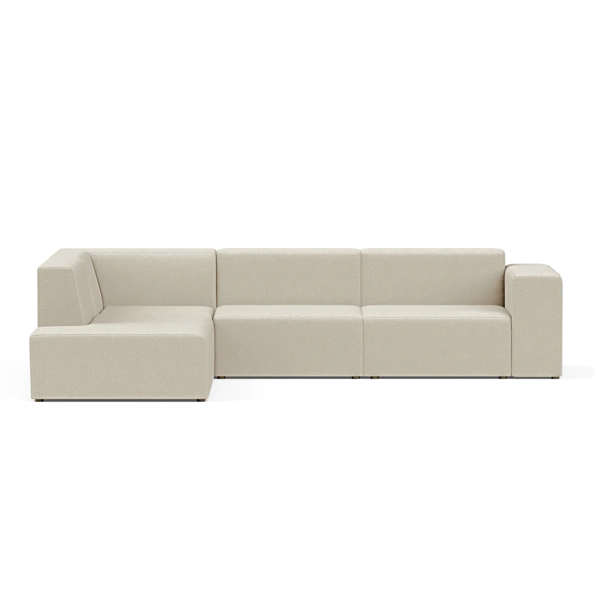 The Four-Seater Form Sectional is a modern, beige sofa featuring clean lines and a minimalist design. It includes a chaise lounge section on the left, all set against a plain, black background.