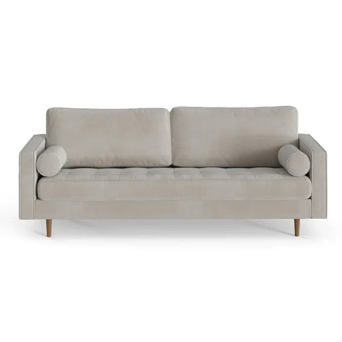 The Geo 84'' Upholstered Sofa is a modern piece in light gray, showcasing two square back cushions and two cylindrical bolster pillows, all supported by wooden legs against a white background.