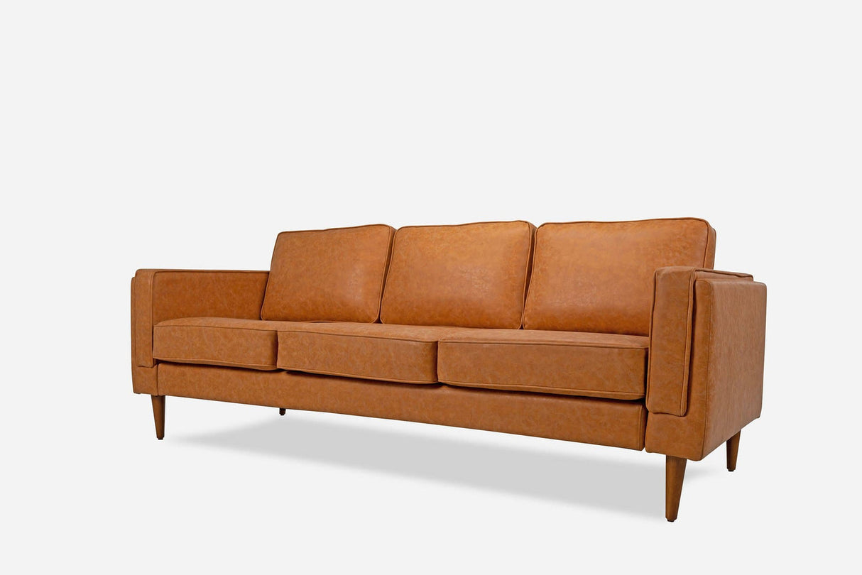 A mid-century modern vegan leather Albany Sofa in brown, featuring three seat cushions and wooden legs, set against a plain white background.