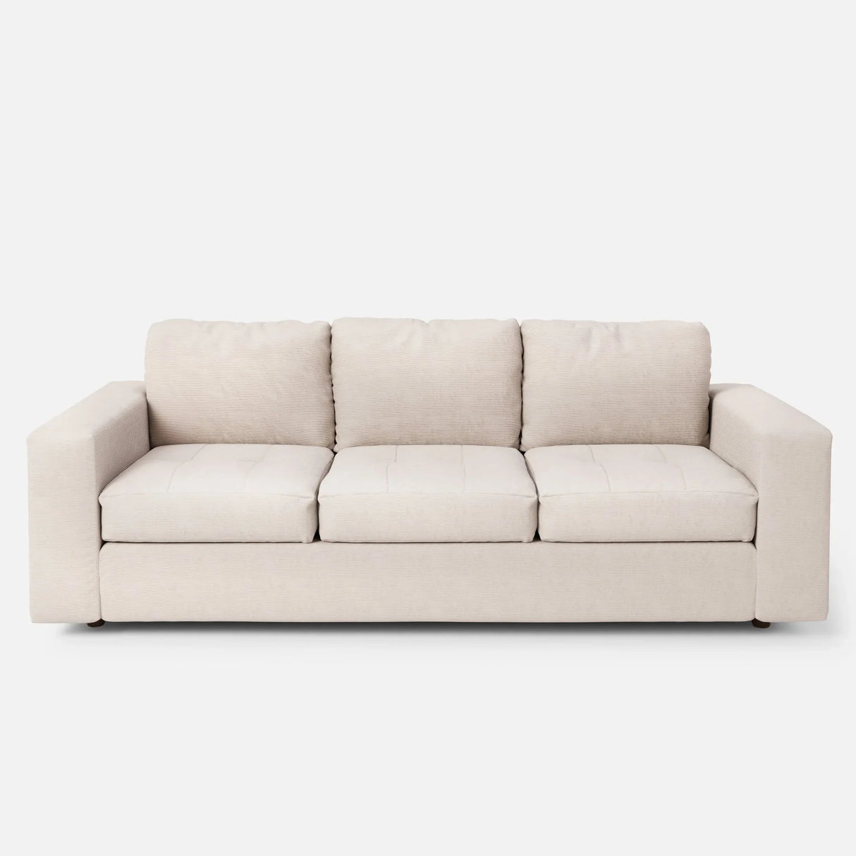 The Marc Tufted Sofa, a beige three-seater with plush cushions and a minimalist design, is set against a plain white background.