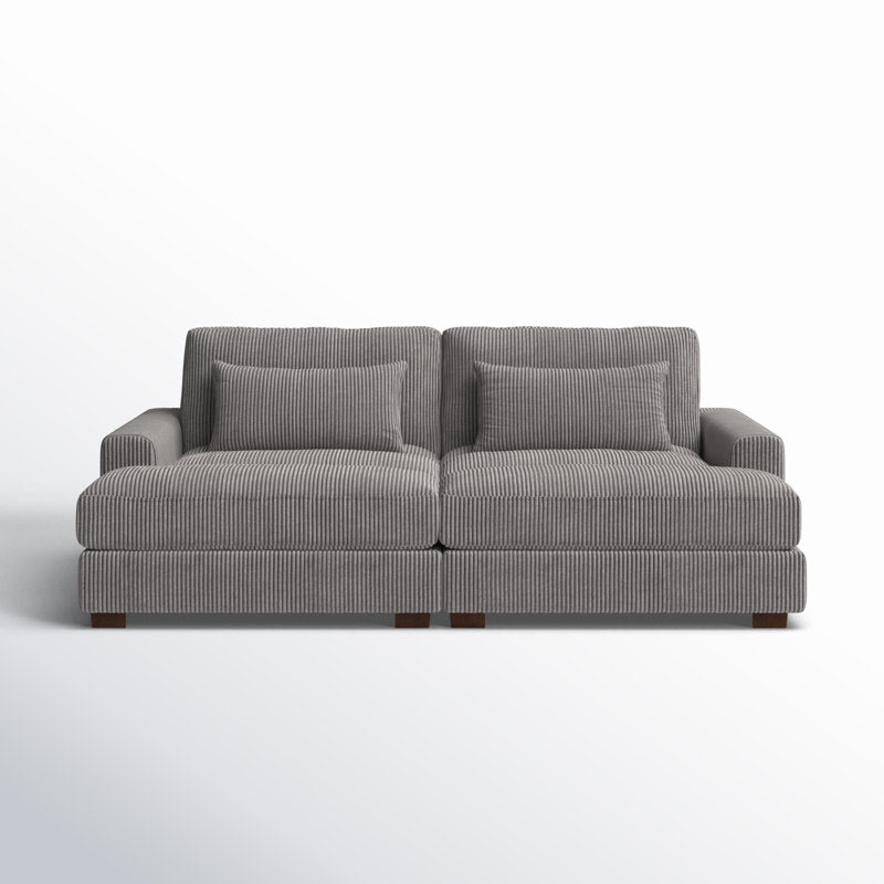 The Etta Avenue Mordecai 90'' Square Arm Sofa is a gray, two-seater with a ribbed texture and comes with matching cushions. It features wide armrests and rests on wooden legs, set against a plain white background.