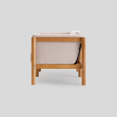 Side view of the Haven Sofa in beige with a wooden frame set against a light gray background. The design highlights clean lines and a minimalist aesthetic.