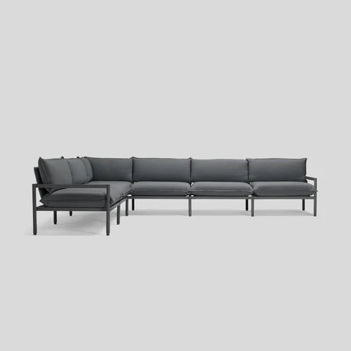 The Terra Sectional is a modern, minimalist L-shaped sofa featuring sleek black metal frame and dark gray cushions, all set against a plain light gray background.
