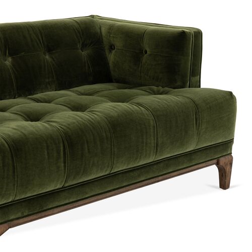 The Caledonia Sofa in Sapphire Olive Velvet is a corner design with visible button tufting on its upholstery, featuring a wooden frame and offering a modern, elegant look.