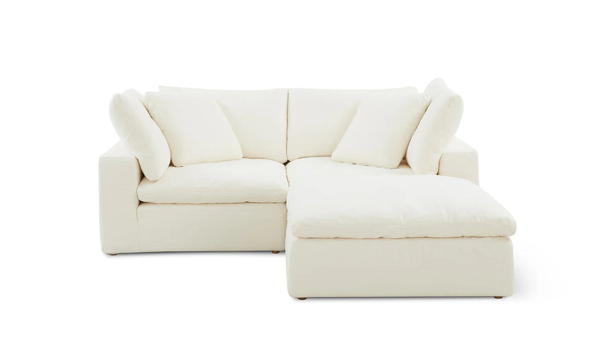 The Movie Night 3-Piece Modular Sofa, a white L-shaped sectional with plush cushions, is showcased against a plain white background. It boasts a right-side chaise section, offering a modern and minimalist appearance.