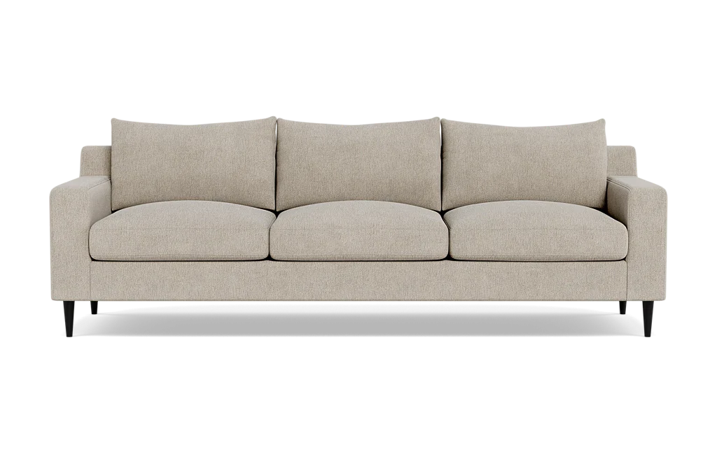 The Sloan Custom 3-Seat 95" Sofa is a beige, three-seater piece featuring clean lines and a modern design. It includes three large seat cushions and three matching back cushions. The sofa is styled with short, black legs and embodies a minimalist aesthetic, perfect for contemporary interiors.
