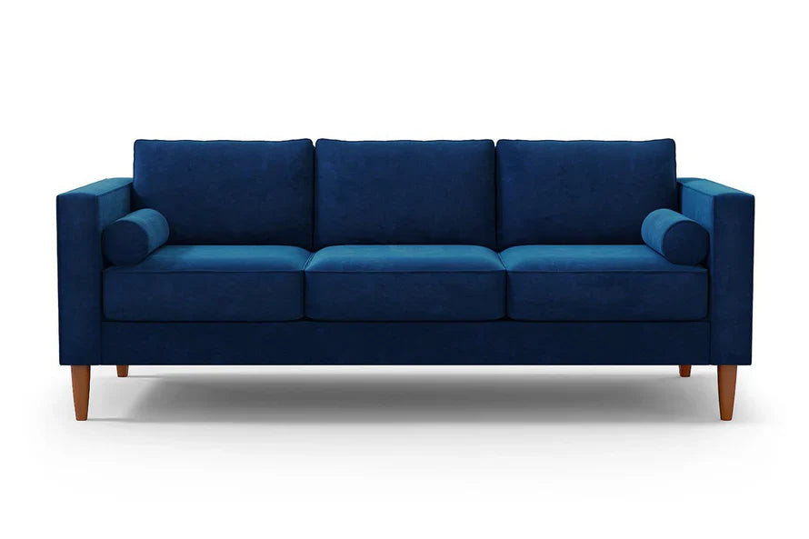 Product Description: The Samson Sofa is a contemporary, deep blue three-seater with square arms and wooden legs. It boasts three back cushions and includes two cylindrical bolster pillows, all showcased against a plain white background.