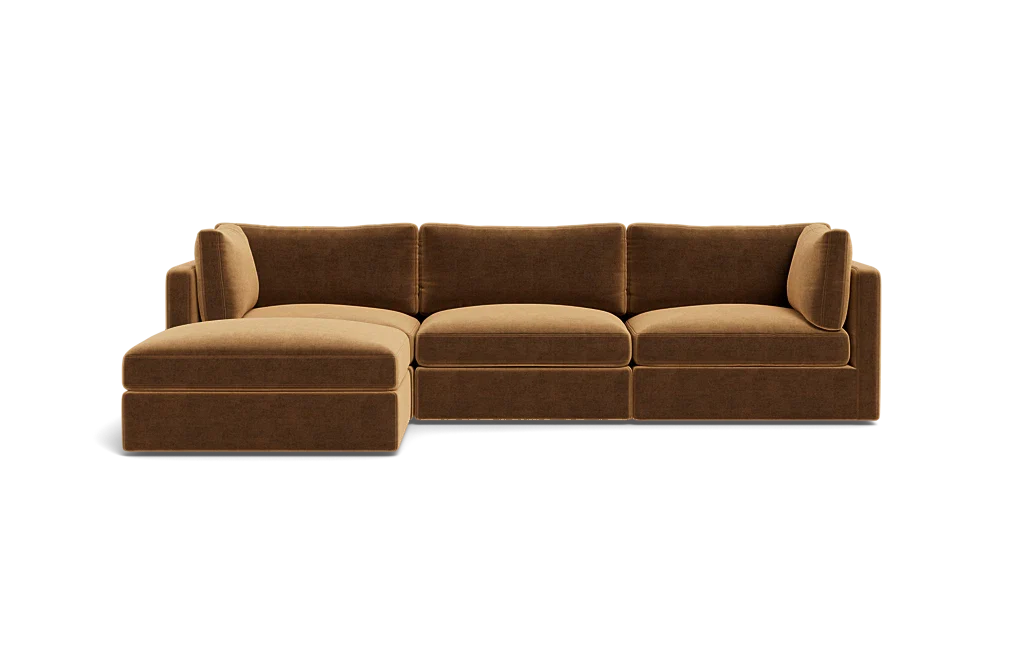 The Tatum Modular 3 Seat Chaise Sectional is a brown sofa with three seat cushions and an extended chaise lounge on the left. It showcases plush back cushions and a modern design, set against a plain black background.