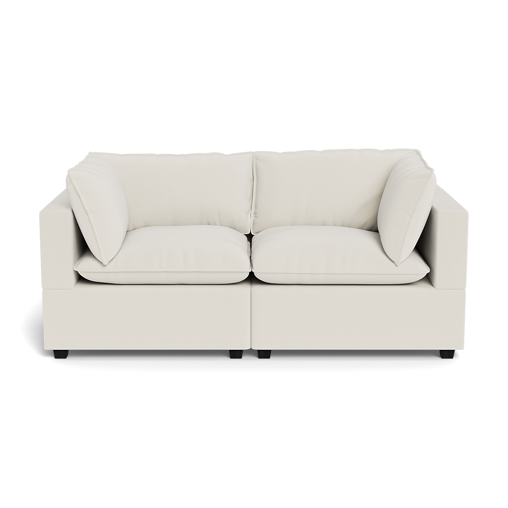 The Kova Pillow Cushion Sofa 86" is a modern, off-white two-seater with square arms, plush seat cushions, and matching back and side pillows, shown from the front against a plain background.