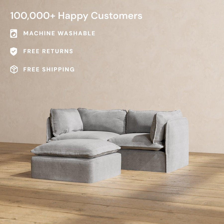 A stylish and contemporary Modular Performance 2-Seater in light gray, paired with a matching ottoman, sits elegantly on a wooden floor. Text on the image showcases features such as "100,000+ Happy Customers," "Machine Washable," "Free Returns," and "Free Shipping.