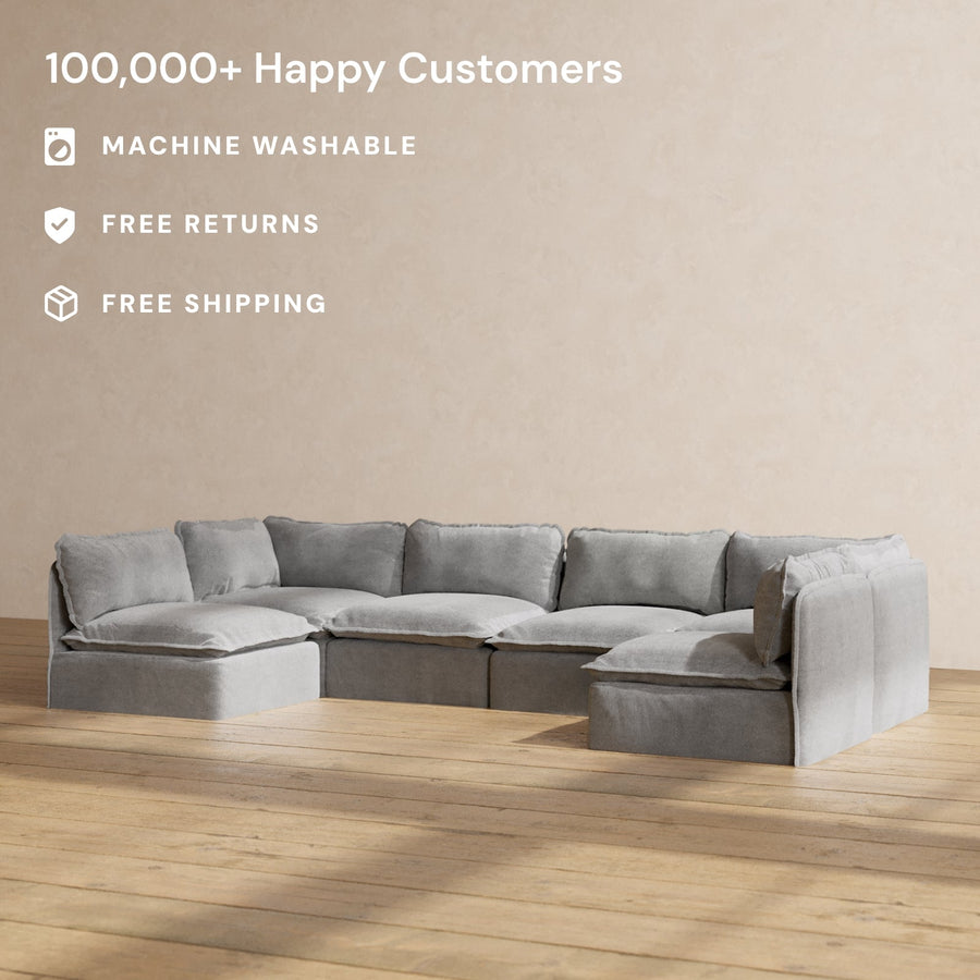 The Modular Performance 6-Seater Open-Ends U-Sectional Plush Weave Ash is placed on a wooden floor against a plain beige wall. Text highlights "100,000+ Happy Customers," "Machine Washable," "Free Returns," and "Free Shipping.