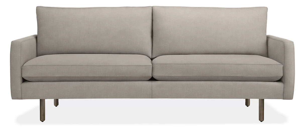 The 86" Jasper Sofa is a modern, light gray seating option with a clean and minimalist design. It features two seat cushions, two back cushions, and slim metal legs for support. With its sleek and contemporary appearance, it is well-suited for various living spaces.