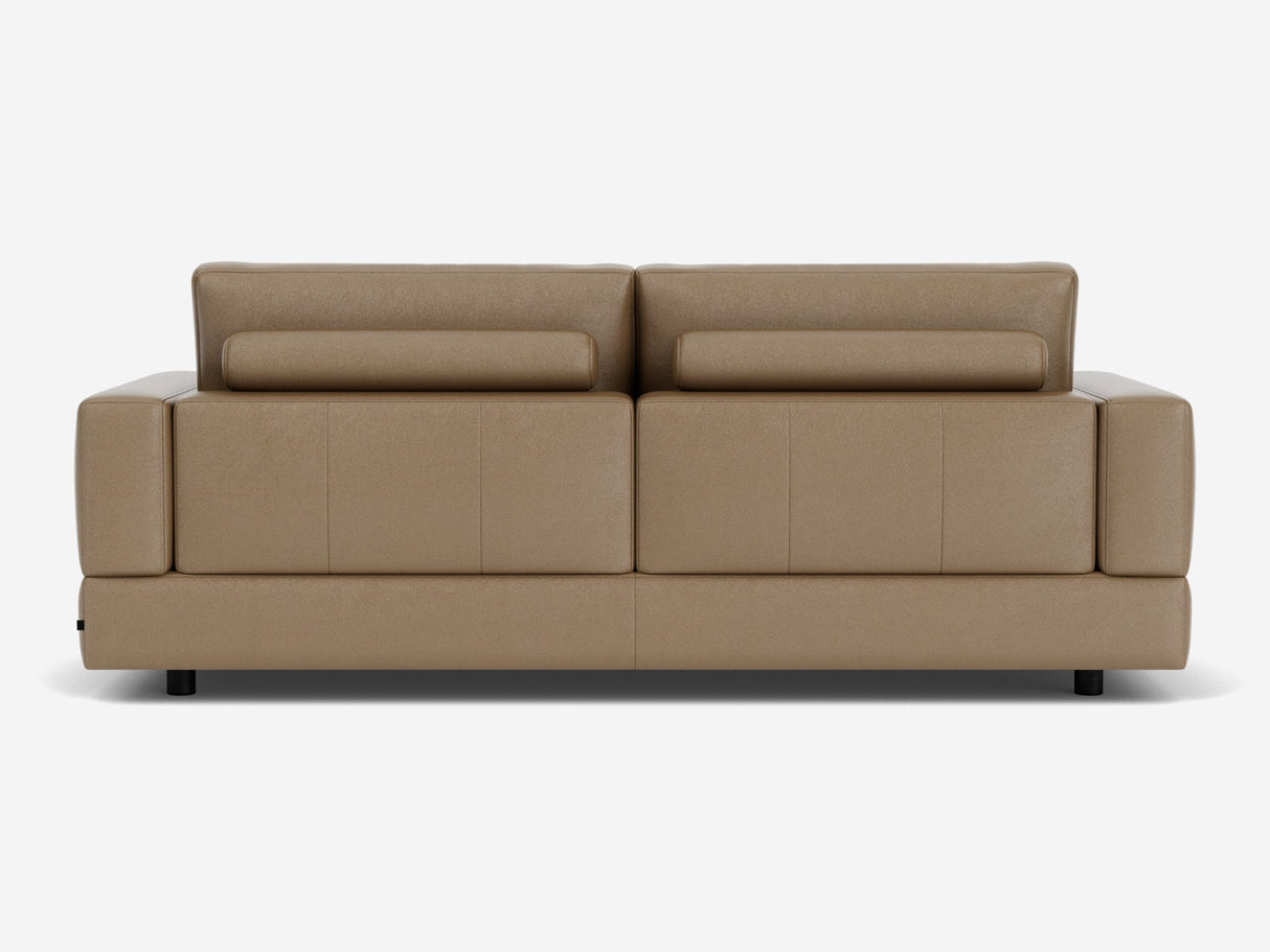 Back view of the Stage Track Sofa, a modern piece crafted in brown leather featuring adjustable headrests and short black legs. This sofa boasts a sleek, minimalist design, making it ideal for contemporary interiors.