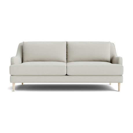 The Kaydan Sofa is a modern piece with a light gray finish, featuring two large cushions and a minimalist design. It boasts a clean, simple appearance with wooden legs, perfectly showcased against a plain white background.