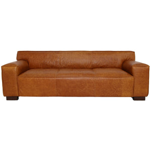 The Morgan Waxy Sofa in Cognac features a modern, rectangular design with wide armrests and a smooth leather texture, set against a plain white background.