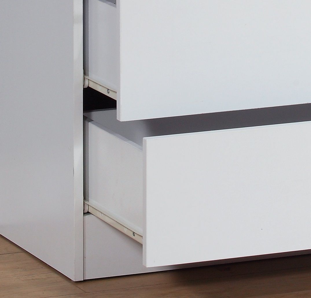 Close-up of a partially open top drawer in the 5 Drawer Chest, showcasing the metal glide rails and inner space, placed on a light-colored wooden floor.
