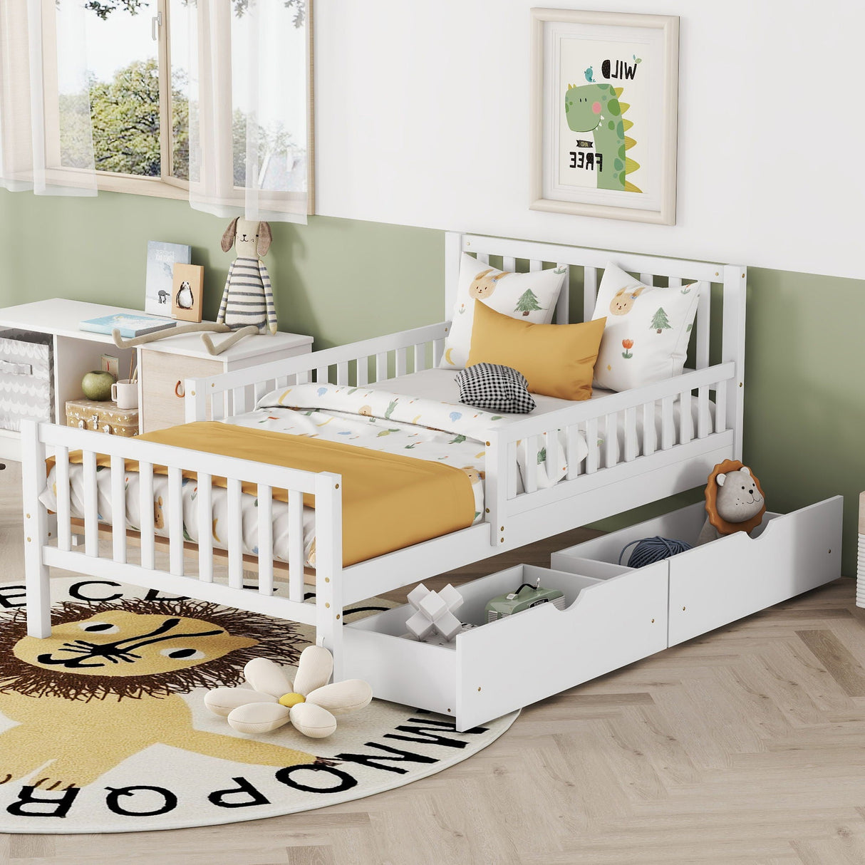 A children's bedroom features a white platform bed with guardrails and two storage drawers, adorned with green and yellow bedding, dinosaur pillows, and stuffed animals. A round lion rug rests on the light wood floor beneath dinosaur wall art above the bed.