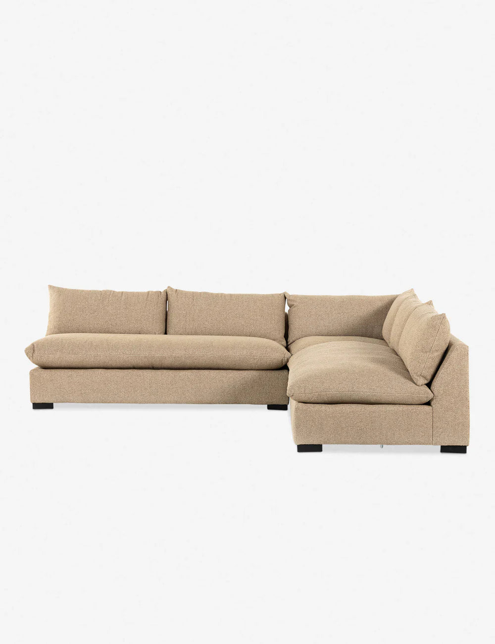The Decima Sectional Sofa, featuring a beige L-shaped design with large cushions and a low-profile aesthetic, is showcased against a plain white background.
