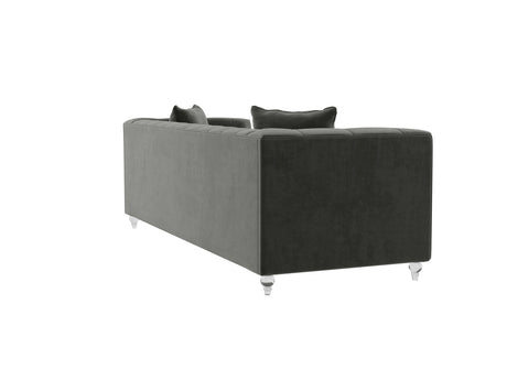 The Bea Velvet Tufted Sofa, shown at an angle on a white background, features a plush, dark gray velvet upholstery with a modern design and back cushions, complemented by clear cylindrical acrylic legs.