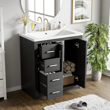 The Ceramic Sink Combo Vanity Set features a sleek sink and faucet with an open cabinet revealing towels and toiletries inside. It includes 3 drawers, soft closing doors, and comes with a large round mirror nearby, a leafy plant, and natural light streaming through a window.