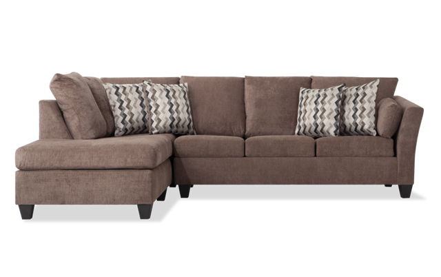 The Virgo Charcoal 119'' 2 Piece Chaise Sectional features an L-shape design with plush cushions and matching chevron-patterned throw pillows. It has wooden legs and provides ample seating space, perfect for a comfortable and modern living room setup.