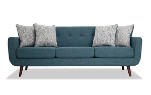 The Bettie 86'' Sofa is a modern teal piece with three cushions and wooden legs, complemented by four patterned throw pillows in a black and white design, all showcased against a plain white background.