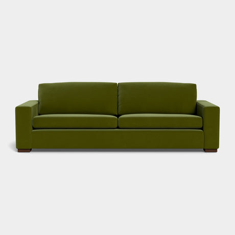 The Barton Sofa features a minimalist design with clean lines and square armrests, displayed against a plain white background. It includes two seat cushions and two back cushions, offering a contemporary look in modern green.