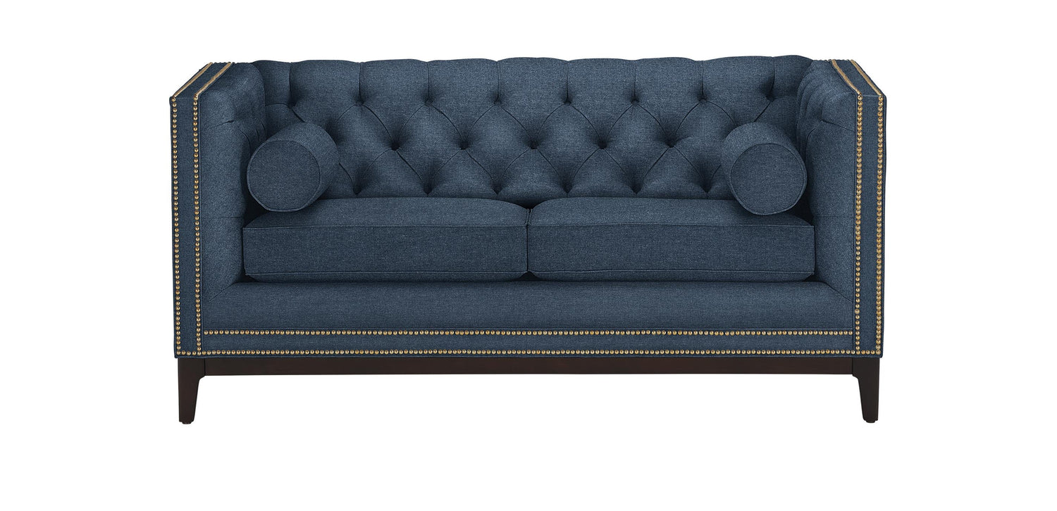 The Anderson Loveseat is a rectangular sofa in dark teal, featuring a tufted design with nailhead trim along the edges. It comes with two seat cushions and two cylindrical bolster pillows, all supported by dark wooden legs.