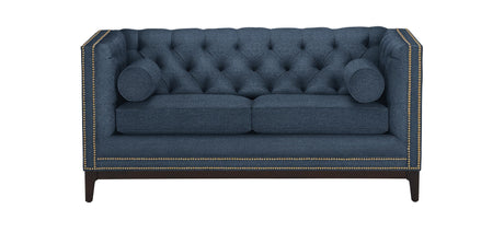 The Anderson Loveseat is a rectangular sofa in dark teal, featuring a tufted design with nailhead trim along the edges. It comes with two seat cushions and two cylindrical bolster pillows, all supported by dark wooden legs.