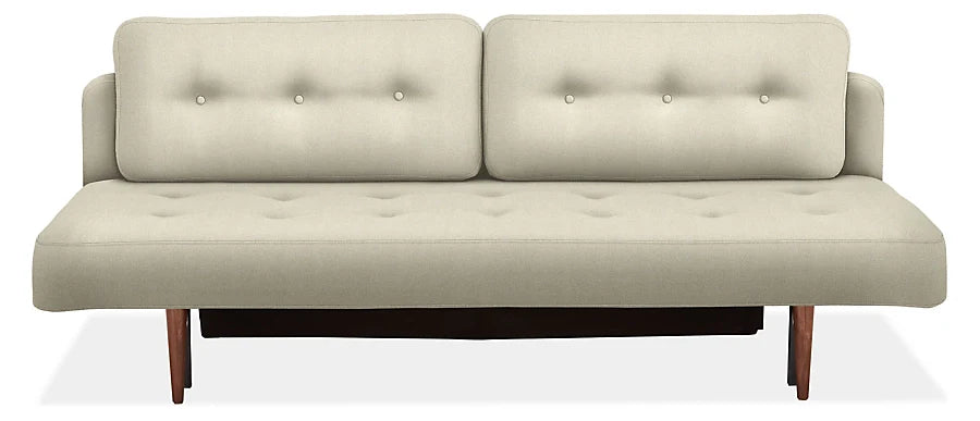 Introducing the Deco Convertible Sleeper Sofa: a modern, minimalist beige sofa featuring button tufting on the backrest and seat. This sleek design is complemented by wooden legs, embodying simplicity and elegance.