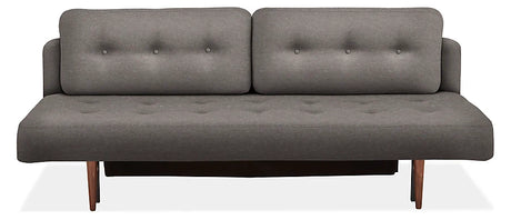 The Deco Convertible Sleeper Sofa is a contemporary gray piece with a minimalist design, boasting two back cushions and a flat seat, both adorned with button-tufted details. It features wooden legs and exudes a sleek and stylish look.