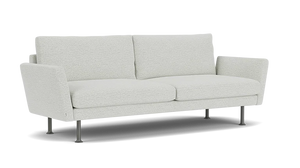 The Form 92" Sofa is a modern piece with light gray upholstery, straight lines, and a minimalist design. It features two seat cushions, two back cushions, and thin metal legs that contribute to its contemporary look.