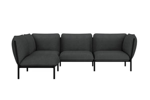 The Kumo Corner Sofa Left with Armrest features a modern design with dark gray upholstery and sleek black legs. Its L-shaped modular configuration showcases simple, clean lines, making it an ideal fit for a contemporary interior setting.