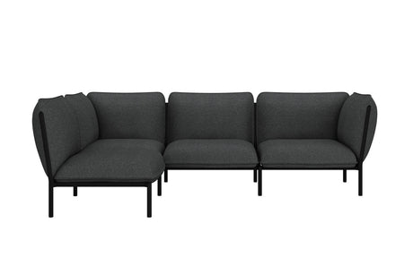 The Kumo Corner Sofa Left with Armrest features a modern design with dark gray upholstery and sleek black legs. Its L-shaped modular configuration showcases simple, clean lines, making it an ideal fit for a contemporary interior setting.