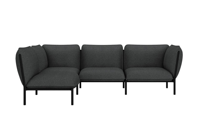 The Kumo Corner Sofa Left with Armrest features a modern design with dark gray upholstery and sleek black legs. Its L-shaped modular configuration showcases simple, clean lines, making it an ideal fit for a contemporary interior setting.