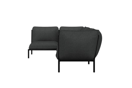 The Kumo Corner Sofa Left with Armrest is a modern, dark green sectional sofa featuring a minimalist design. Thin black metal legs and firm cushions form its L-shaped arrangement, while the plain white background emphasizes its sleek and contemporary style.