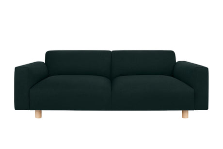 Introducing the Koti 2-seater Sofa, a dark green, modern masterpiece with a minimalist design. It features plush, flat cushions, wide armrests, and short wooden legs against a plain white backdrop.
