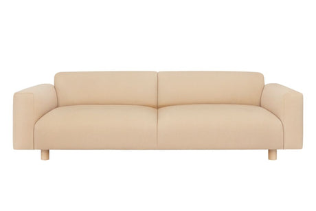 The Koti 3-seater Sofa in beige features a modern design with a low back and wide armrests against a white background. Its clean lines and minimalist aesthetics contribute to its contemporary appearance.