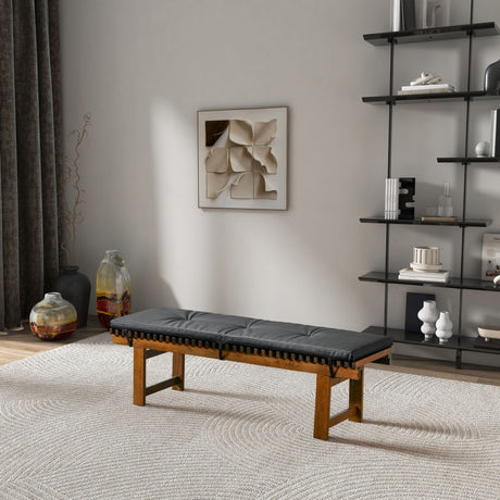 A modern living room with the Lucia bench featuring a black cushion on a light rug. A geometric art piece adorns the wall, and a black shelf displays decorative objects. Large vases rest on the floor near dark curtains.