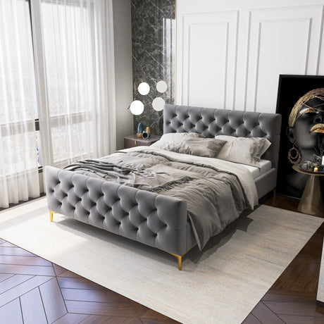 The bedroom features the Bailey - Elegant Design Bed with tufted gray upholstery and gold legs, complemented by gray bedding. A large window with sheer curtains brightens the space, featuring a wooden floor with a white rug. Fashion-themed artwork against the wall adds sophistication.
